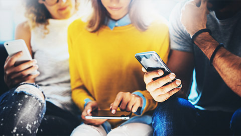 a group friends on their phones