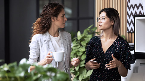 Diverse employees chatting during coffee break