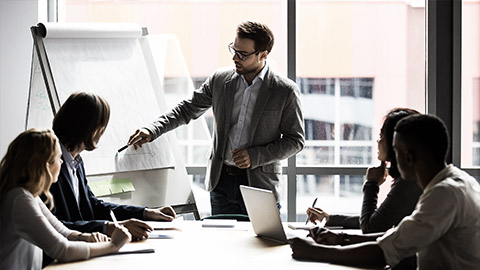 An employee meeting and presenting to colleauges