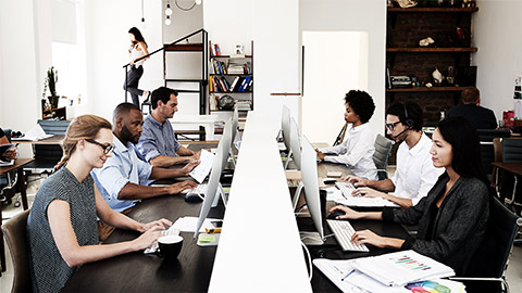 A table full of employees working together face to face