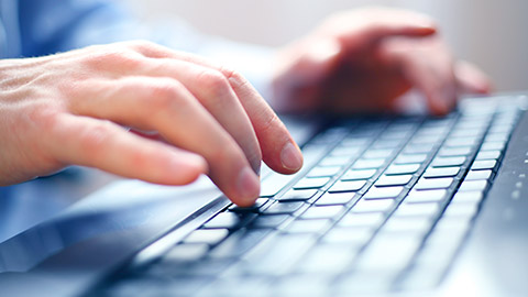 A person typing on a keyboard