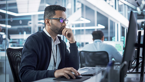 Portrait of Multiethnic Industrial Engineer Developing 3D Model of a Circuit Motherboard on Computer CAD Software in a Factory. Modern Technological