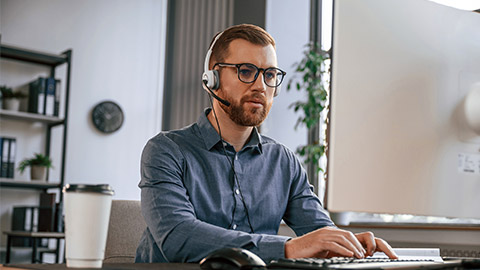 Typing on the keyboard. Man in formal clothes is working in the modern office. Using computer.