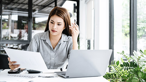 Woman scrutinizing paper