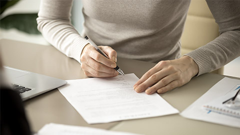 Woman signing document