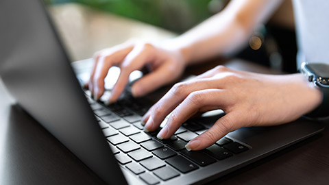 A close view of a person typing on a keyboard