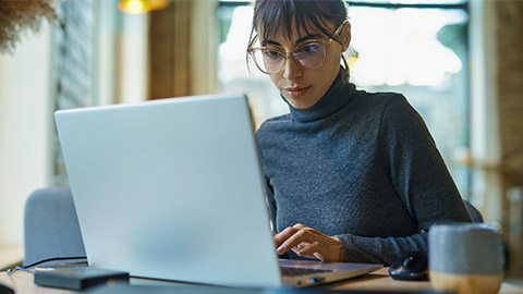 portrait of skilled young female developer in eyeglasses