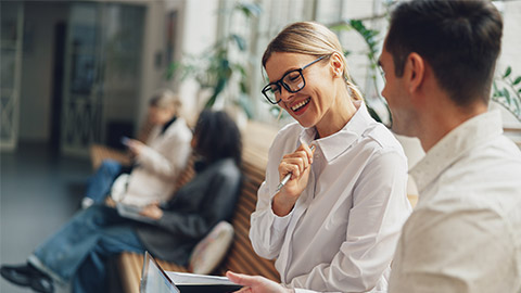 Woman office worker discussing new project with colleague during working day in coworking