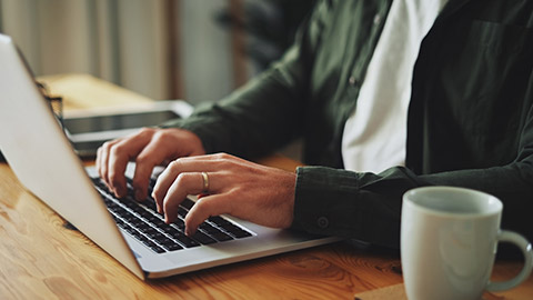 A person typing on a laptop