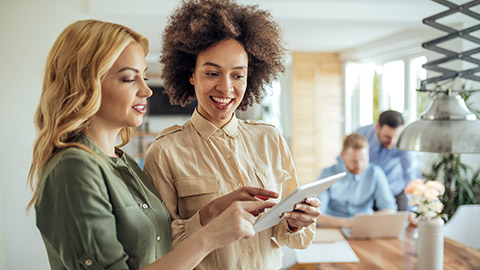 Businesswomen working on a digital tablet together