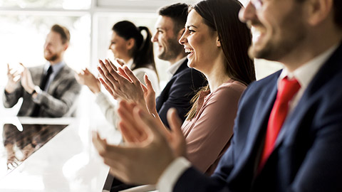 A group of people applausing the presentation