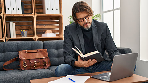 A consellor reading information on a laptop