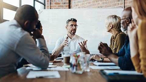 a team leader discussing in a team meeting at an office