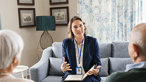 Social worker, talking to old man and woman