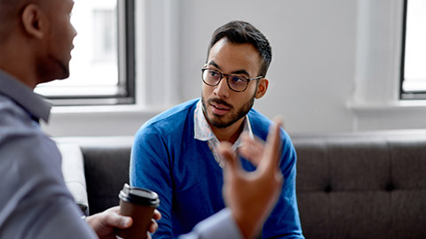 Indian businessman leading a team of creative millenials collaborating on a brainstorm project