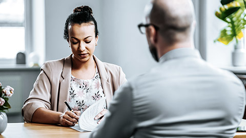 Woman giving interview with a man with eyeglass