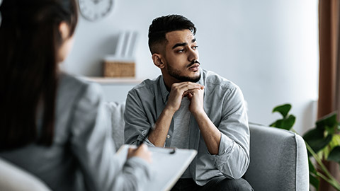 Man shifting gaze while talking to a counsellor