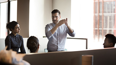 A person counseling people  about goals