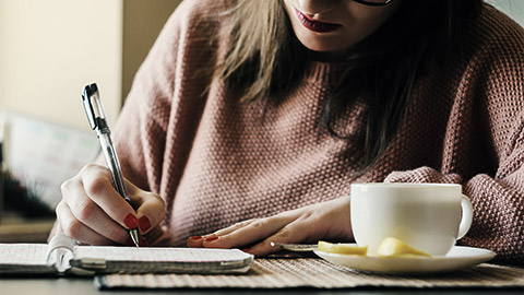 A person writing down goals