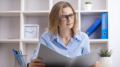 woman sitting in a chair and reading assessing at her working place