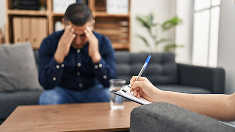 Young latin man patient stressed having psychologist session at psychology clinic