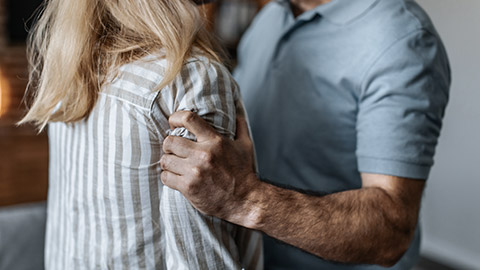 Man grabs woman's arms