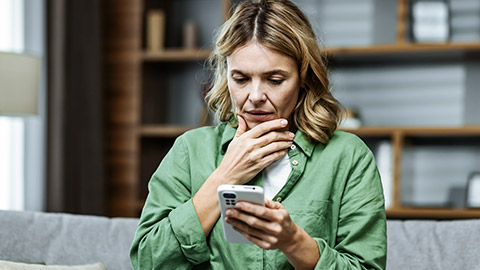 Worried woman using phone