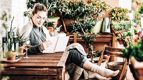 Woman reading, cozy relax at the balcony