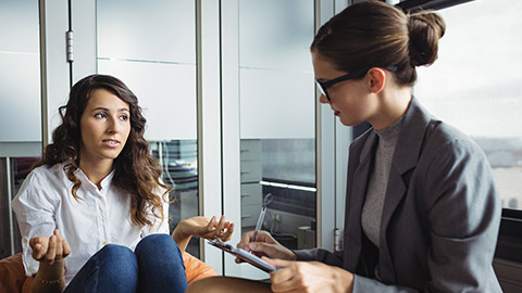 Unhappy woman consulting counselor during therapy