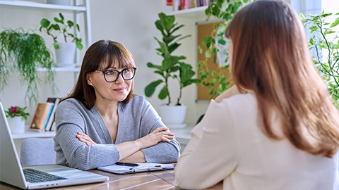 Young female college student at meeting with professional mental therapist