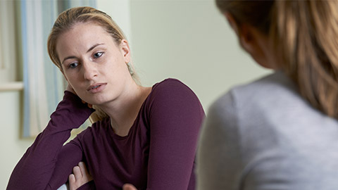 Young Woman Discussing Problems With Counselor