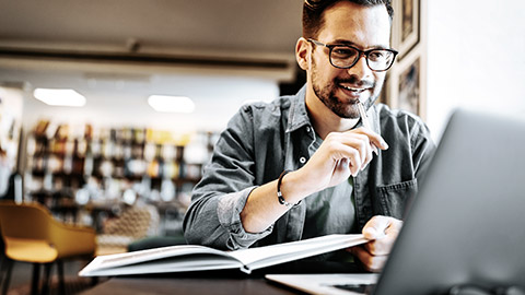 Male student studying in a library