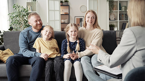 Social worker talking to adoptive family at home