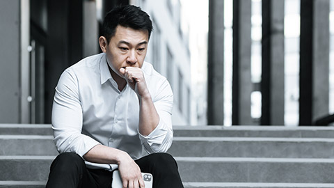 man thinking, sitting on stair