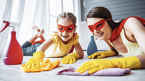 Mother and daughter cleaning the floor