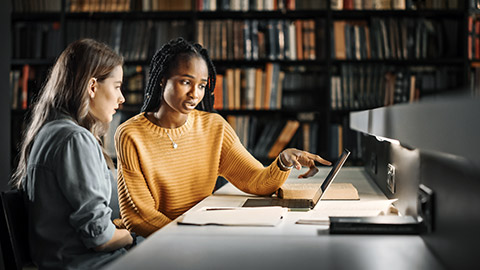 Women studying together in the library