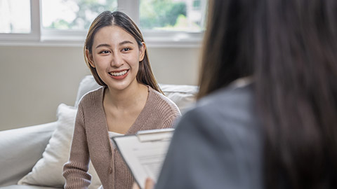 Young woman in a mental therapy session talking with a psychologist in the office