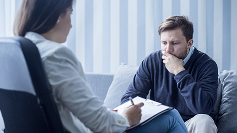 Female psychiatrist or psychotherapist talking with patient