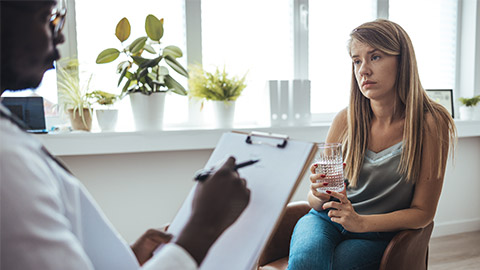 Young woman visiting therapist counselor