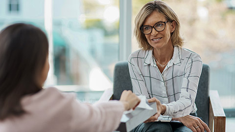 psychologist offering her patient tissues during a therapeutic session