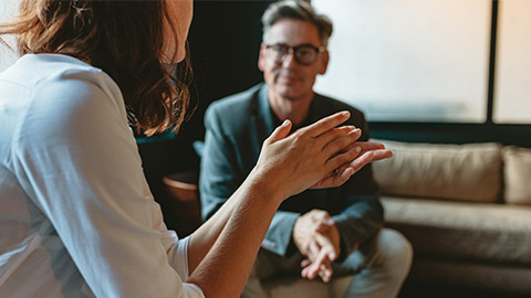 Two business people discussing in office lounge