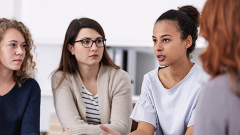 women supporting each other during psychotherapy group meeting