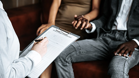 woman filling up form infront of the couple