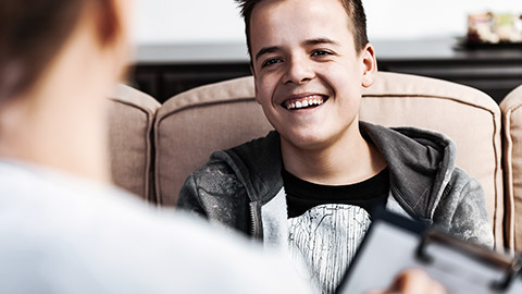 boy smiling with counsellor