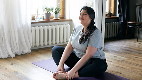 Cheerful attractive young overweight woman in activewear choosing healthy lifestyle