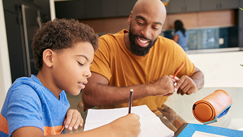 Father Helping Son Studying Homework