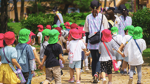 A group of young children with their supervisors outdoors