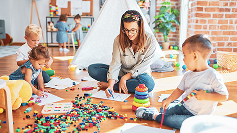 A group of children playing with a childcare worker