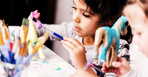 A little girl making crafts