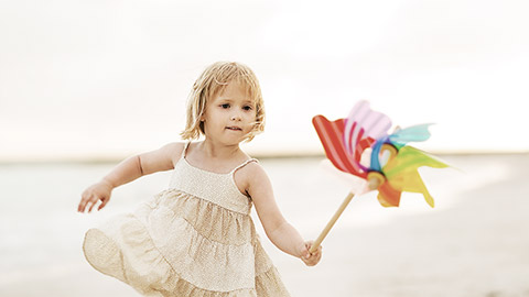 A child playing with a paper bird